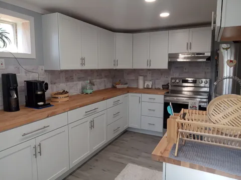 Kitchen with wood counters and tile backsplash from a Cennami project